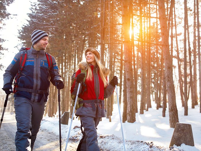Couple on winter hike with poles