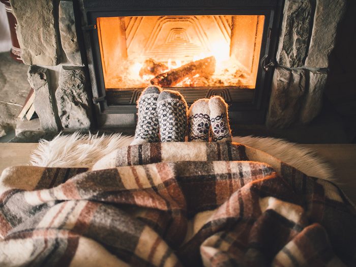 Cozy couple in socks in front of fireplace