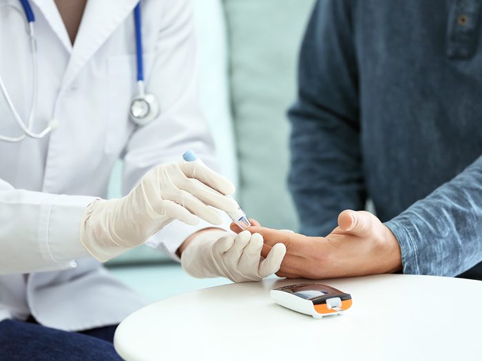 Diabetic patient with doctor taking blood test