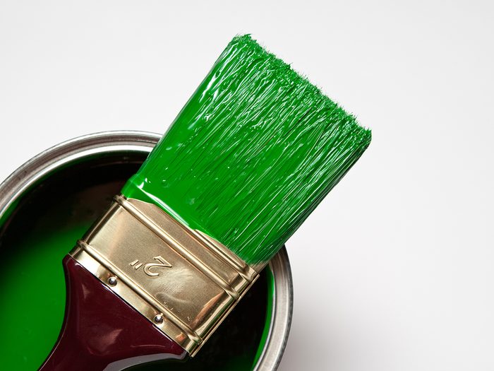 Glossy green paint brush and paint can