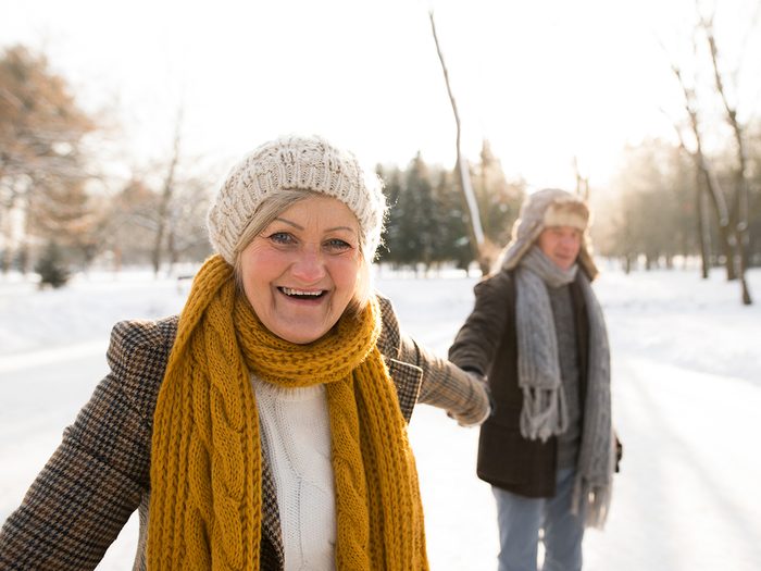 Health benefits of cold weather - mature couple walking in winter