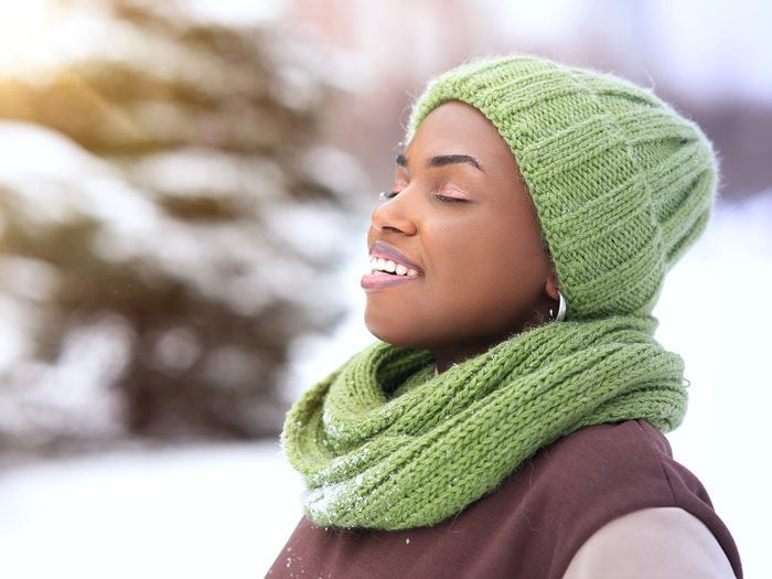 Health benefits of cold weather - winter woman breathing freely