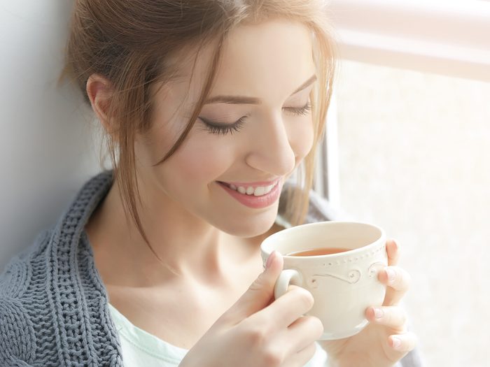 Health benefits of tea - young woman drinking tea