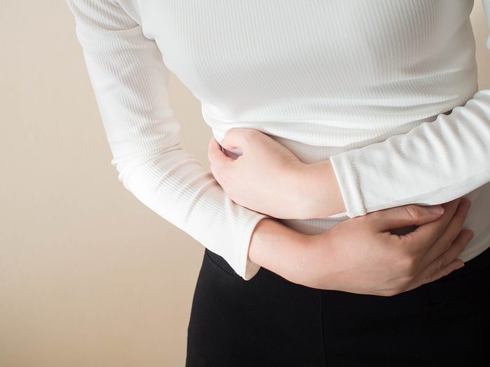 How to heal your gut - woman with stomach cramps