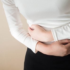 How to heal your gut - woman with stomach cramps