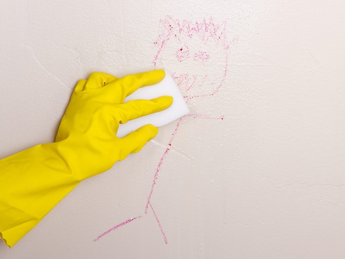 Magic Eraser cleaning crayon off wall
