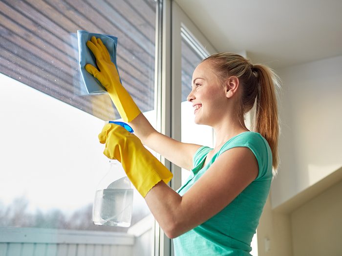 Rubbing alcohol uses - woman cleaning windows