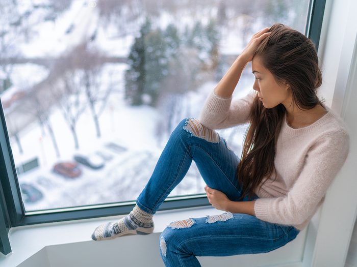 Signs of seasonal affective disorder - depressed woman in winter