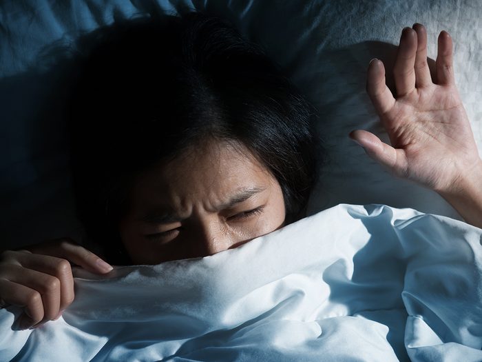 Silent signs of post-traumatic stress - woman in bed