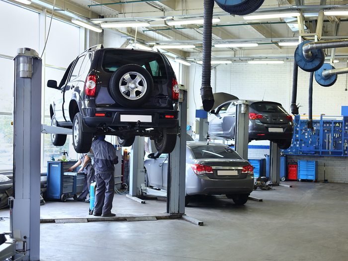 Cars on lifts at mechanic shop