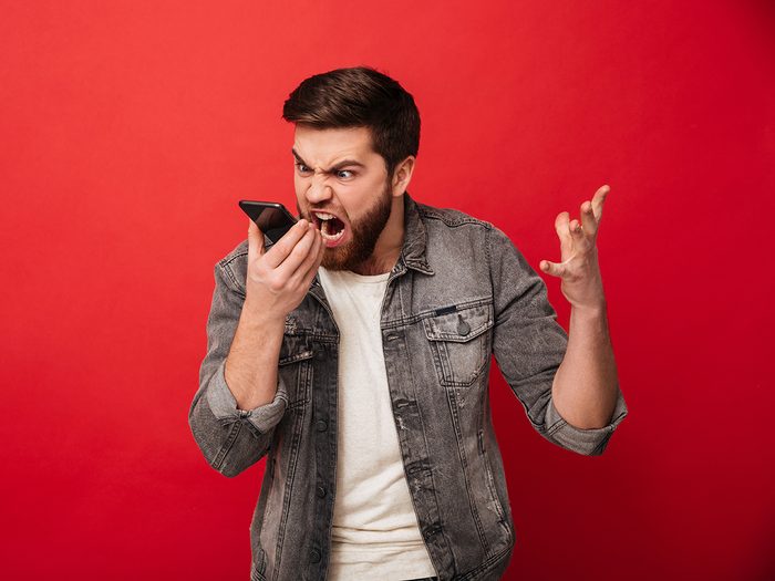 Customer service tips - man yelling into phone