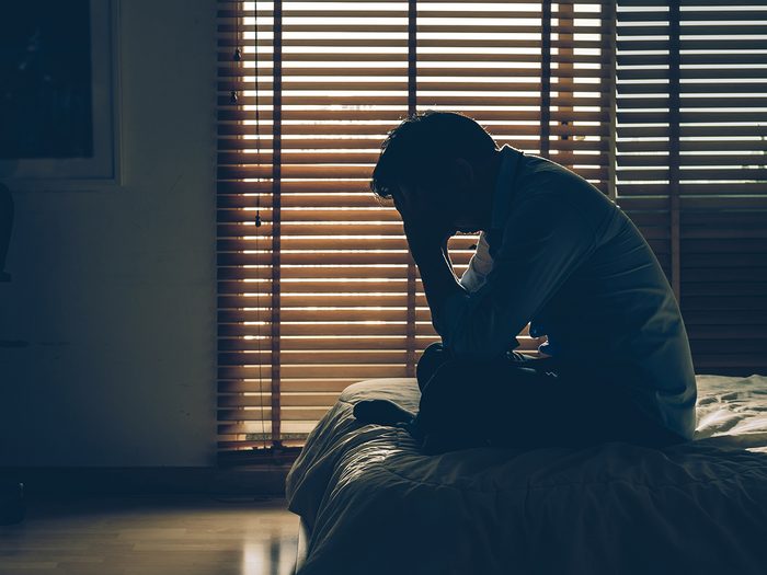 Generalized anxiety disorder symptoms - stressed man in dark