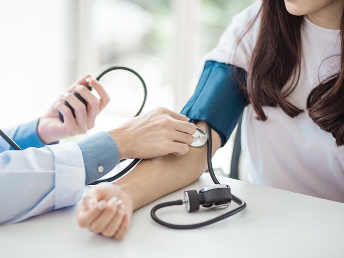 Heart disease symptoms women - woman taking blood pressure