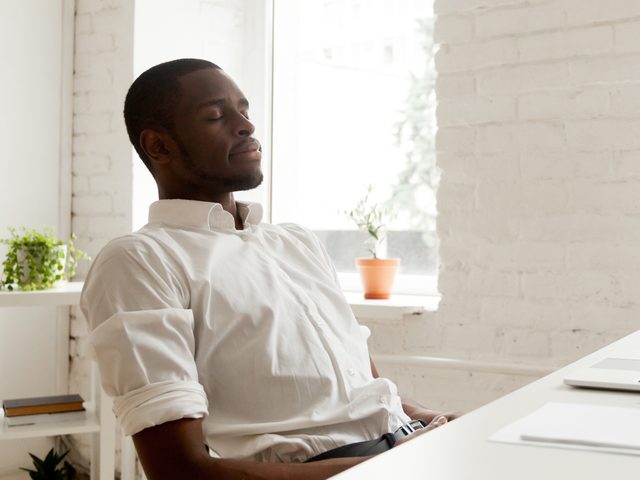 Man at desk engaged in mindfulness meditation