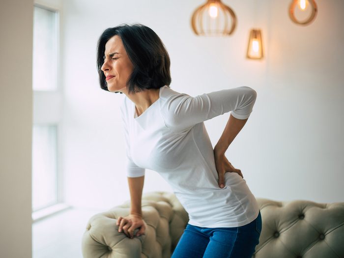 Chronic back pain causes - woman with back pain