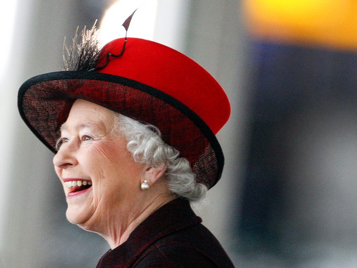Queen Elizabeth II in red hat