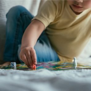 Board Games With My Kids - Mom and son playing board game on bed together
