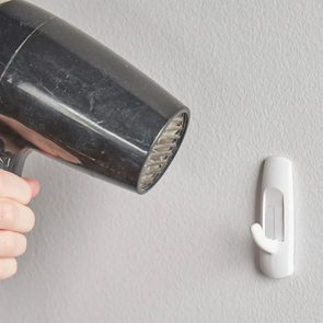 Cleaning hacks for hard-to-remove stuff - hot air hair dryer on adhesive wall hook