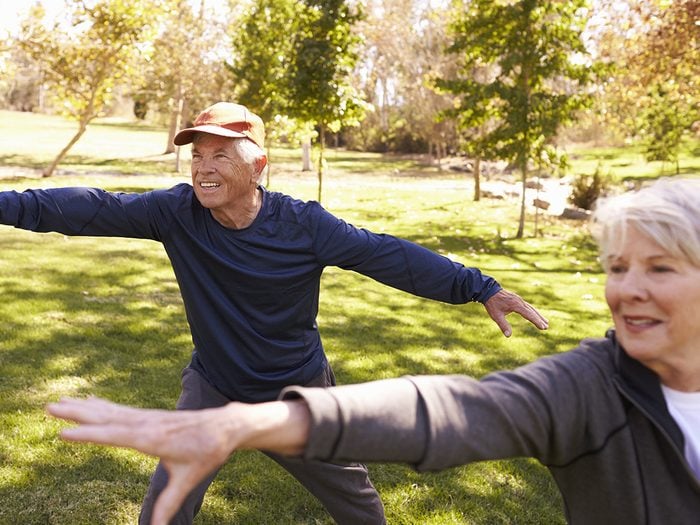 Exercises for seniors - senior couple doing tai chi in park