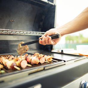 Grilling tips for BBQ season - man grilling food on BBQ