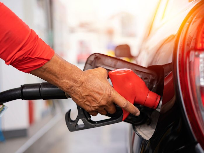 Man filling car with gas - car myths