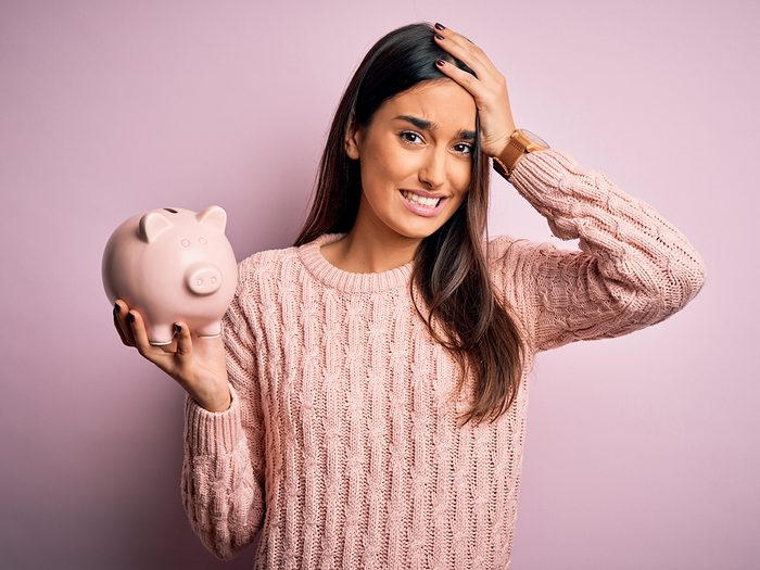 Money mistakes - woman holding piggy bank