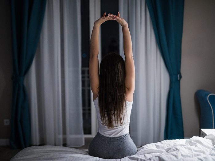 Natural sleep aids that work - woman stretching before bed