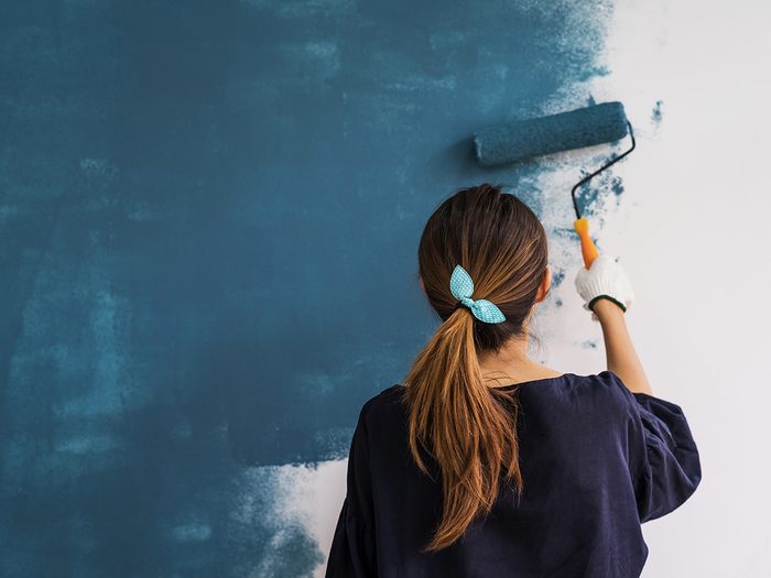 Professional organizer tips - woman painting wall