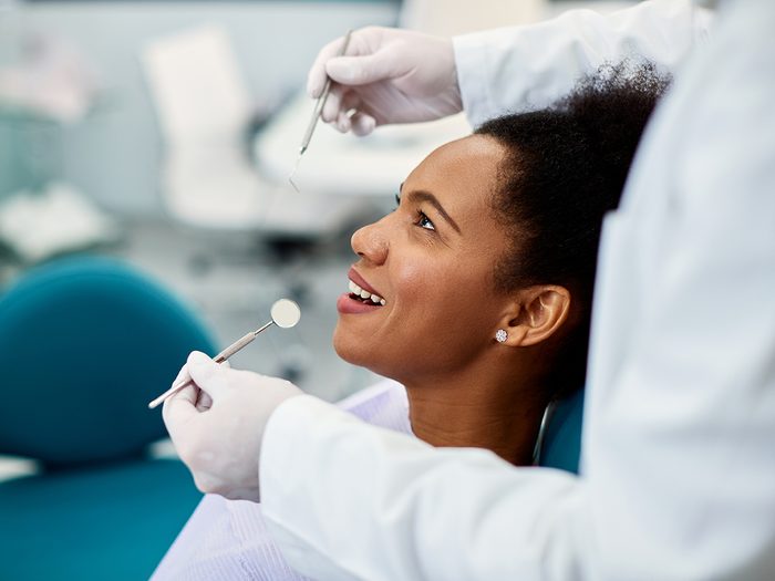 Woman getting dental exam at dentist office