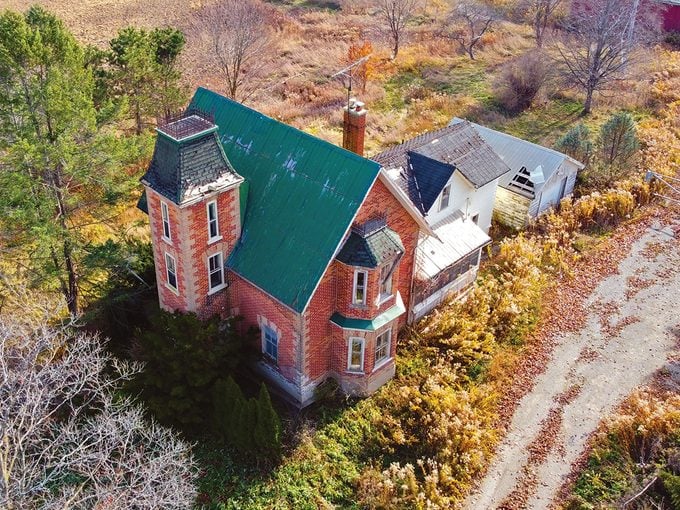 Abandoned places - red brick mansion drone shot