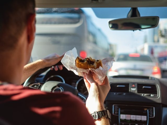 Eating burger while driving