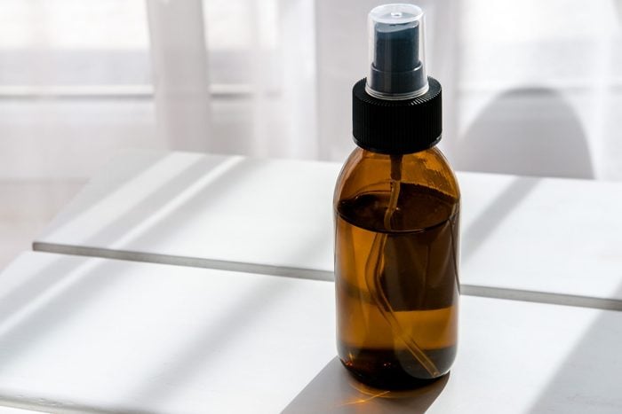 Glass Brown Spray Bottle With Organic Cosmetics On White Table Direct Light Beauty Blogging Minimalism Concept