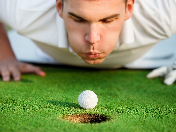 Golf jokes - player blowing on ball
