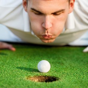 Golf jokes - player blowing on ball