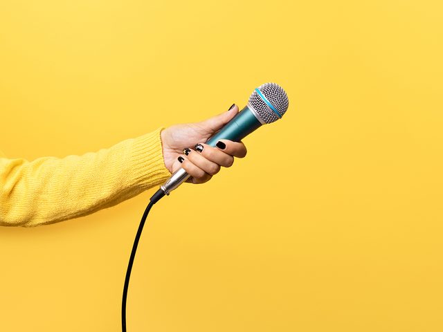 Hand holding microphone