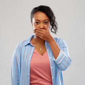 What causes bad breath - woman covering mouth