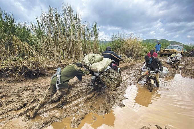 Democratic Republic Of Congo - a soldier pushing groceries through the mud