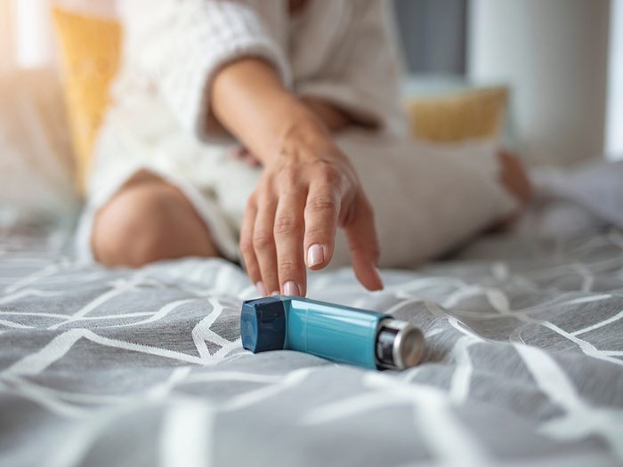 Asthma - woman reaching for inhaler