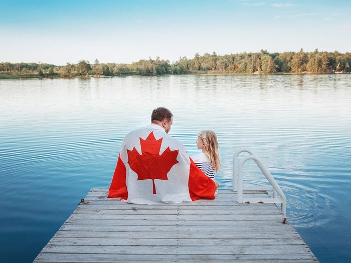 Facts about Canada - sitting on lakeside dock with daughter
