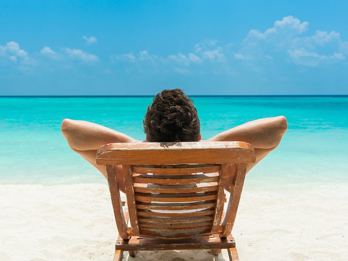 Man lounging on Caribbean beach