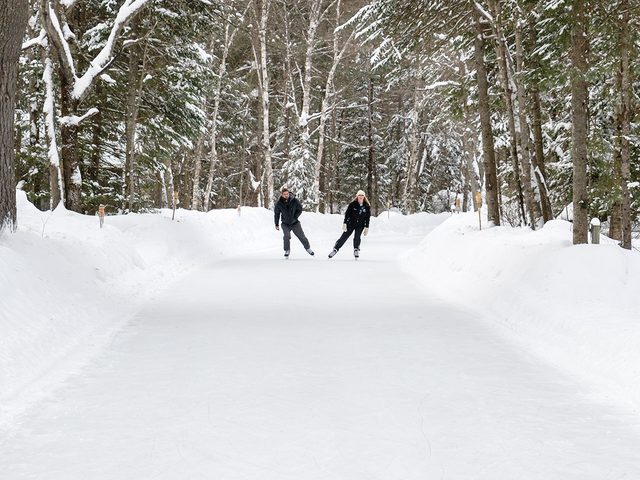 Couple skating on forest trail