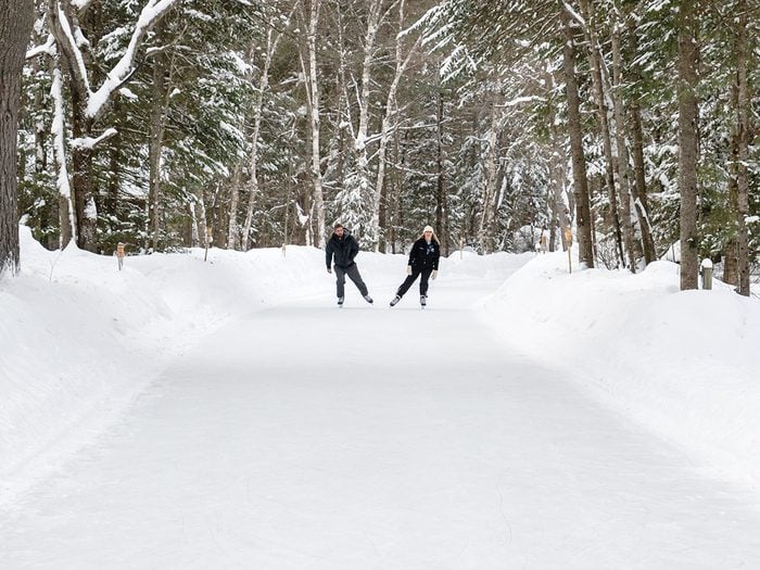 Couple skating on forest trail