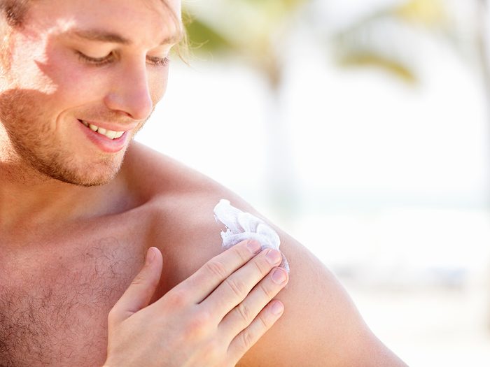 Sunscreen tips - young man applying sunscreen