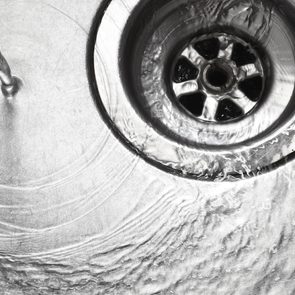 Water swirling down kitchen sink drain