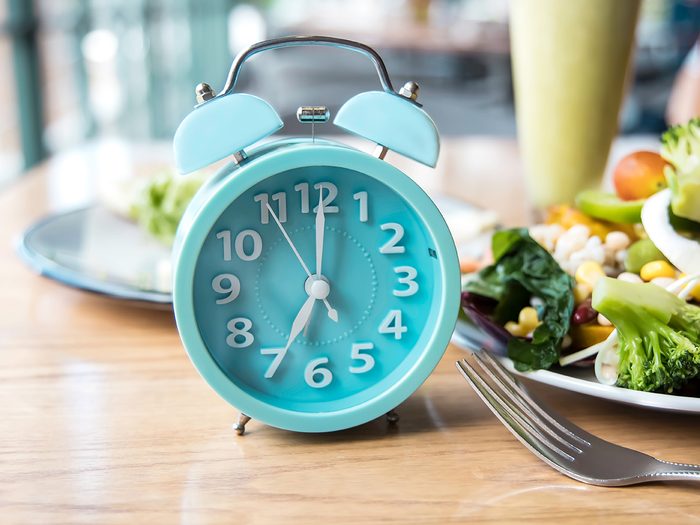 Eating on schedule - alarm clock on breakfast table