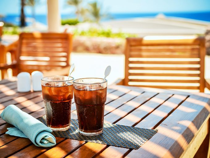 Worst hydration drinks - cola soda pop on beach