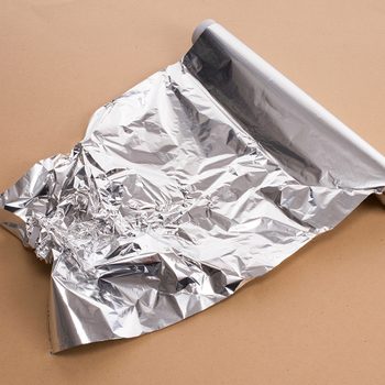 Wrapping leftovers in aluminum foil