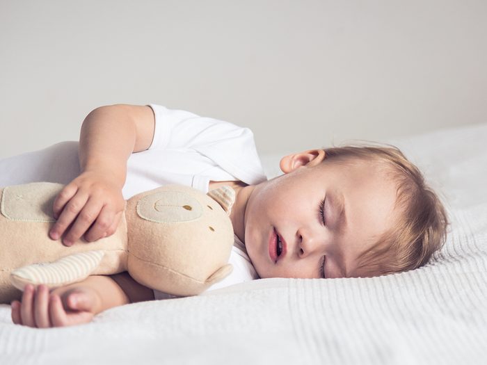 Baby sleeping with stuffed animal