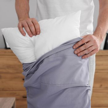 Pillowcase hacks - man putting on pillowcase