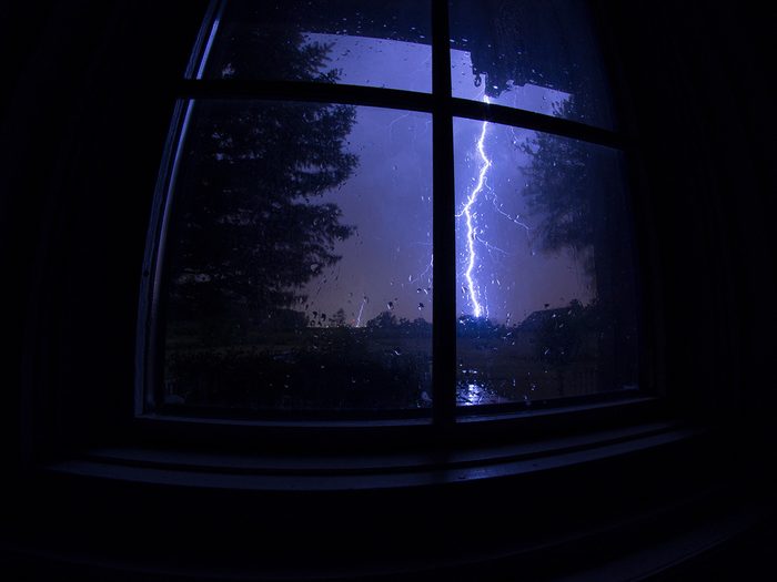 Lightning strike viewed through window